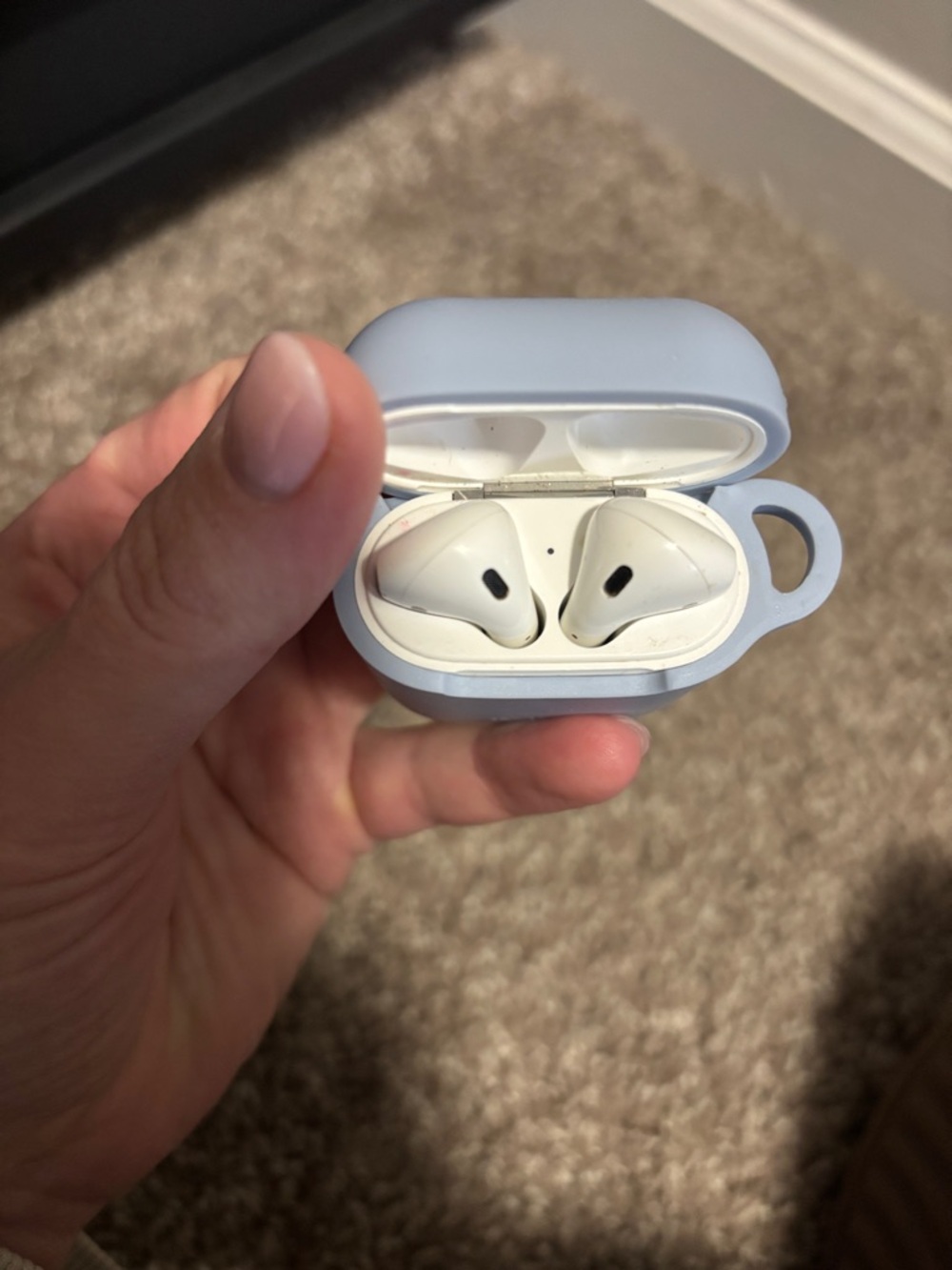 Apple AirPods in Light Blue Protective Case